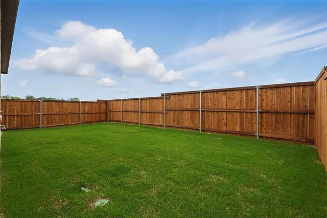 a view of a backyard with plants and a garden