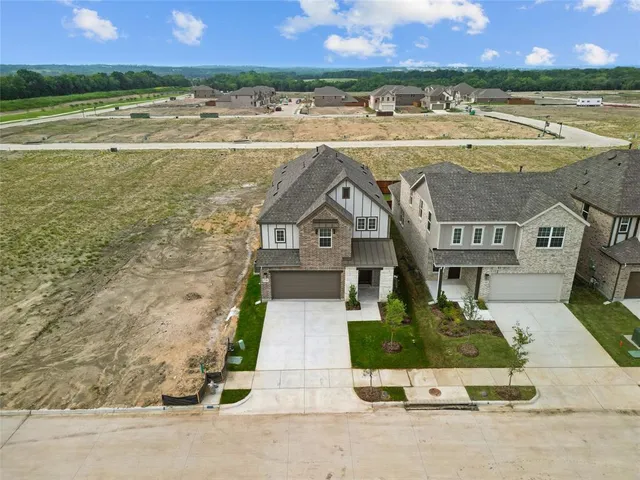 a view of a backyard with wooden fence