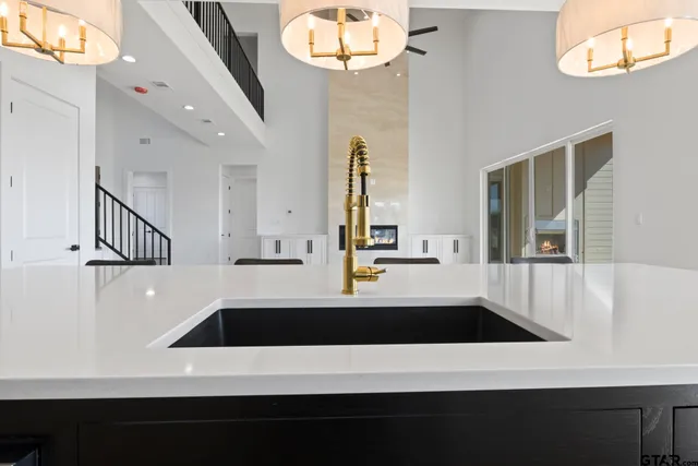 a view of living room with chandelier and fireplace