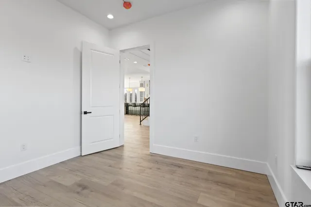a view of a hallway with wooden floor