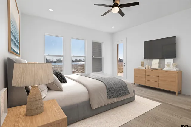 a bedroom with a bed and a flat screen tv