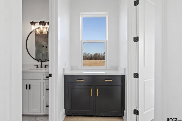 a bathroom with a sink vanity and mirror