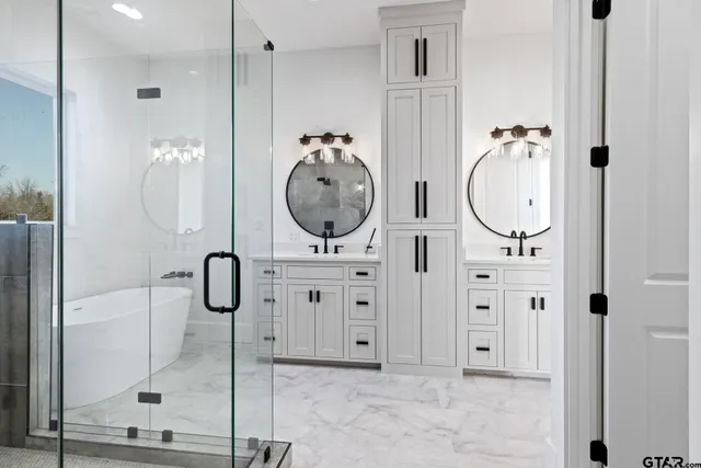 a bathroom with shower a mirror and a sink