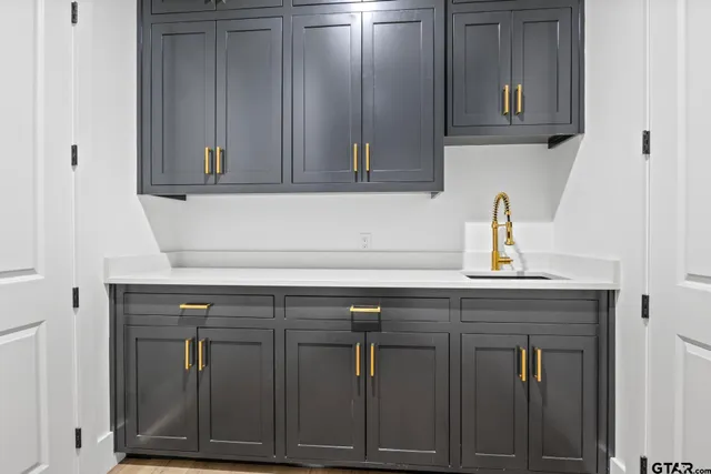 a sink with wooden cabinets