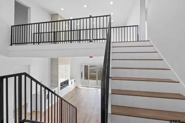 a view of staircase with wooden floor and a window