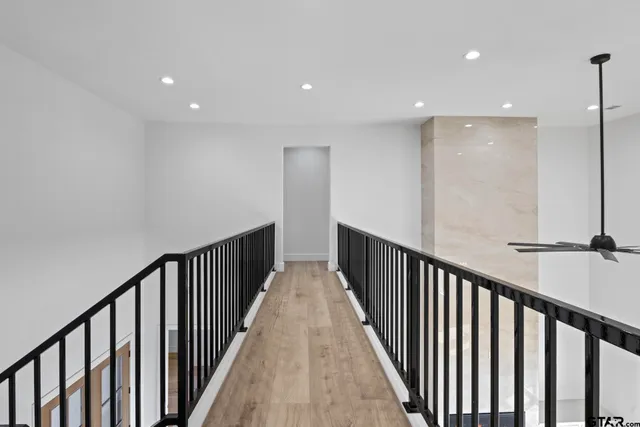 a view of a hallway with wooden floor