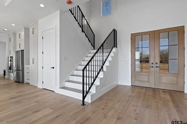 a view of entryway with wooden floor and stairs