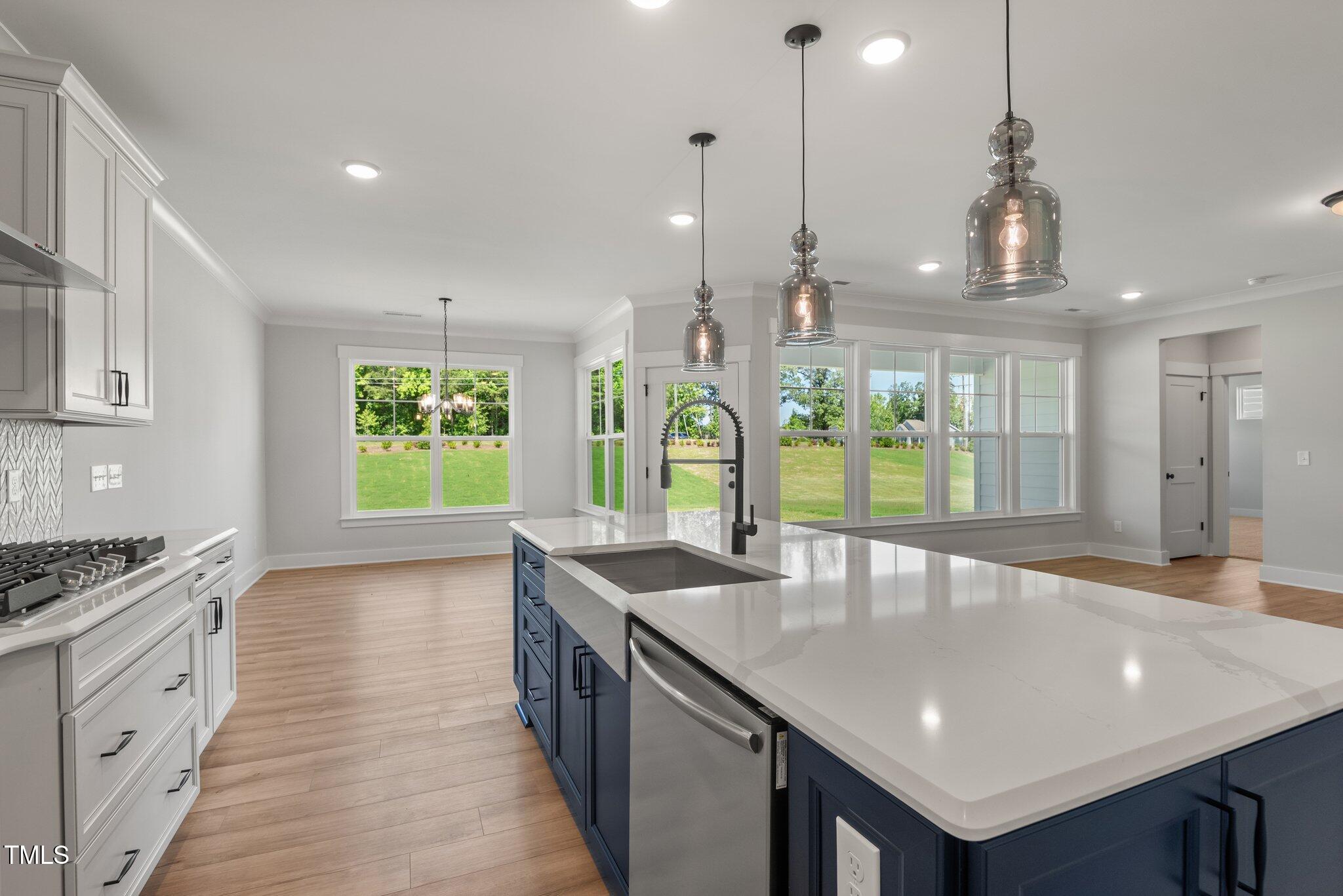 1306 Cricket Street Elon, NC 27244 - Photo 18 of 36 a kitchen with stainless steel appliances granite countertop a kitchen island a stove and a sink