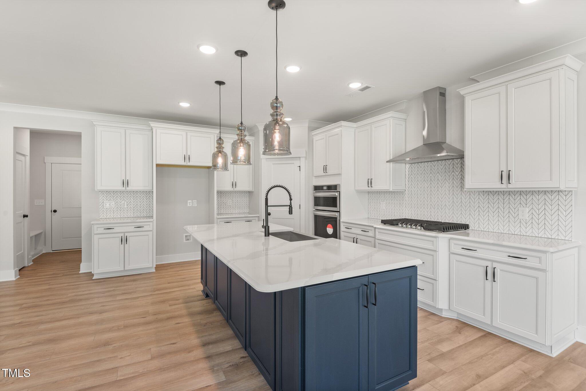 1306 Cricket Street Elon, NC 27244 - Photo 20 of 36 a kitchen with white cabinets sink and stainless steel appliances