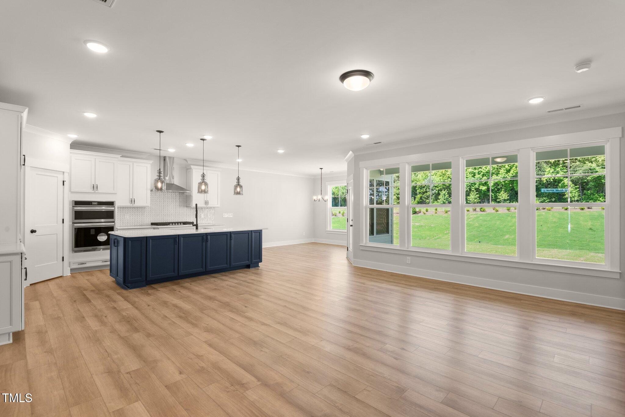 1306 Cricket Street Elon, NC 27244 - Photo 24 of 36 a living room with stainless steel appliances kitchen island wooden cabinets and a large window