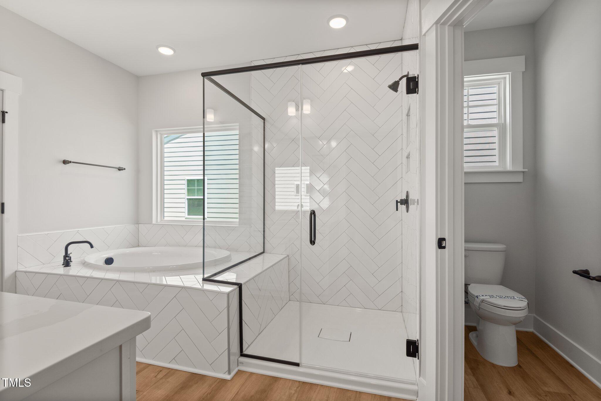 1306 Cricket Street Elon, NC 27244 - Photo 29 of 36 a bathroom with a bathtub shower and toilet