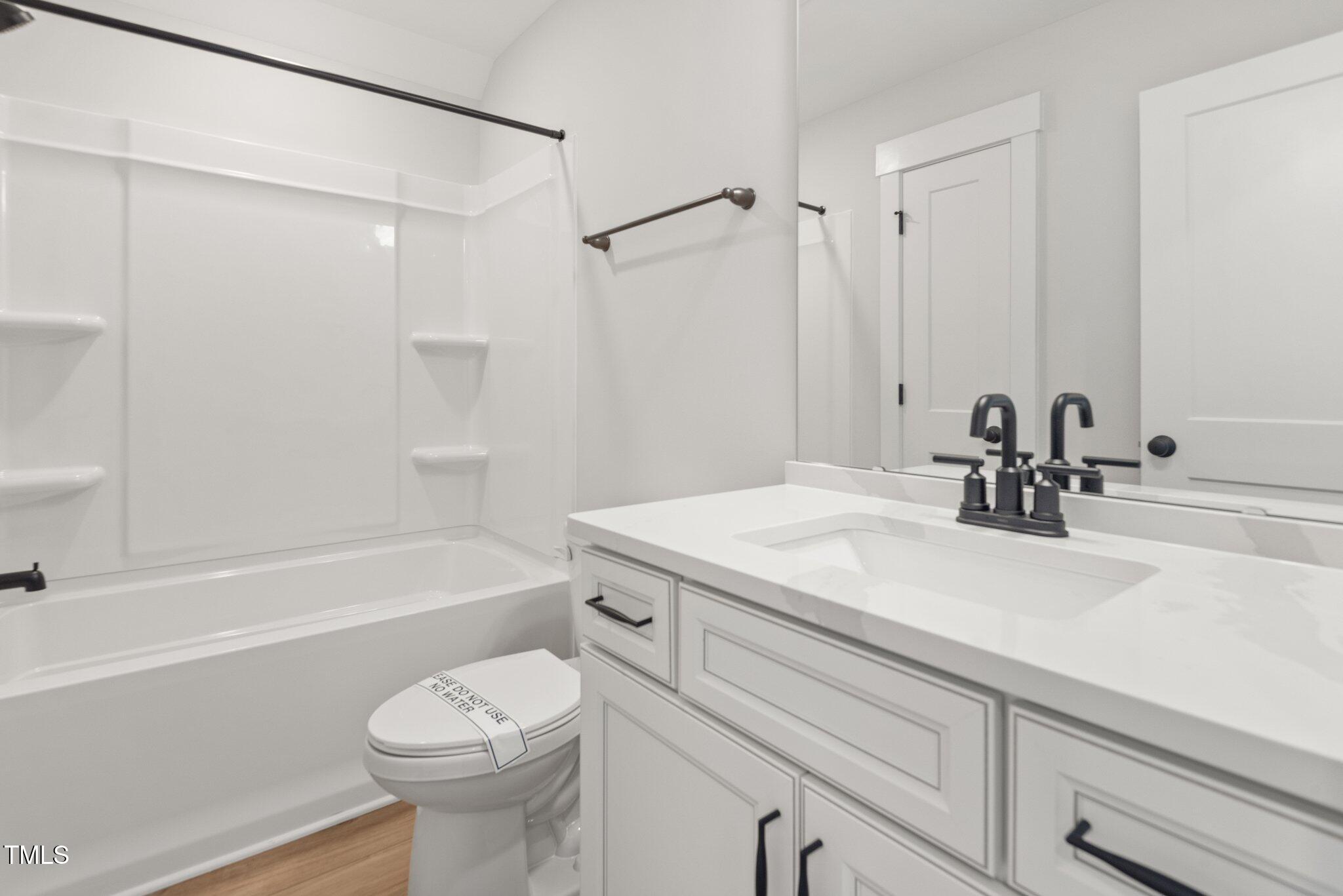 1306 Cricket Street Elon, NC 27244 - Photo 32 of 36 a bathroom with a sink a toilet and a bathtub