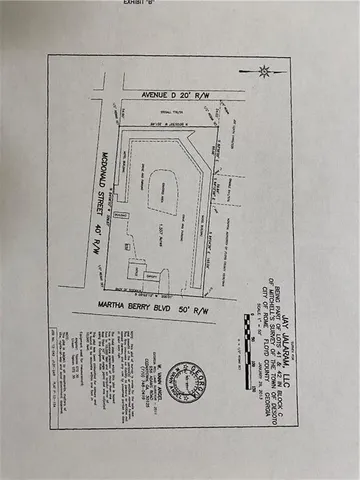 an aerial view of a house with a garden and lake view