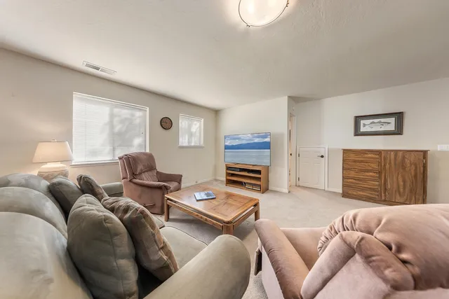 a living room with furniture ceiling fan