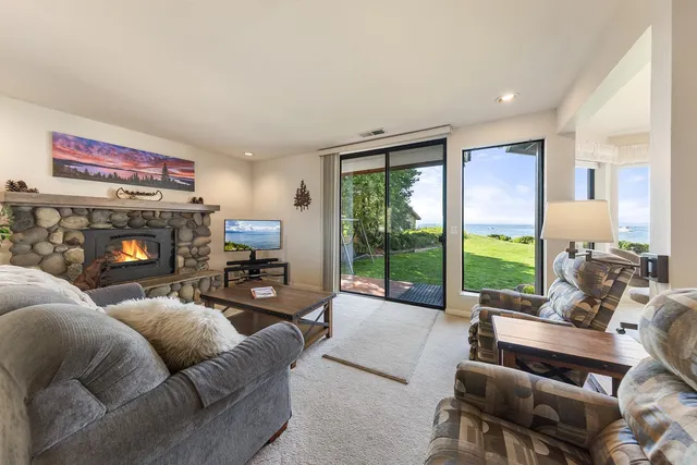 a living room with furniture a large window and a flat screen tv