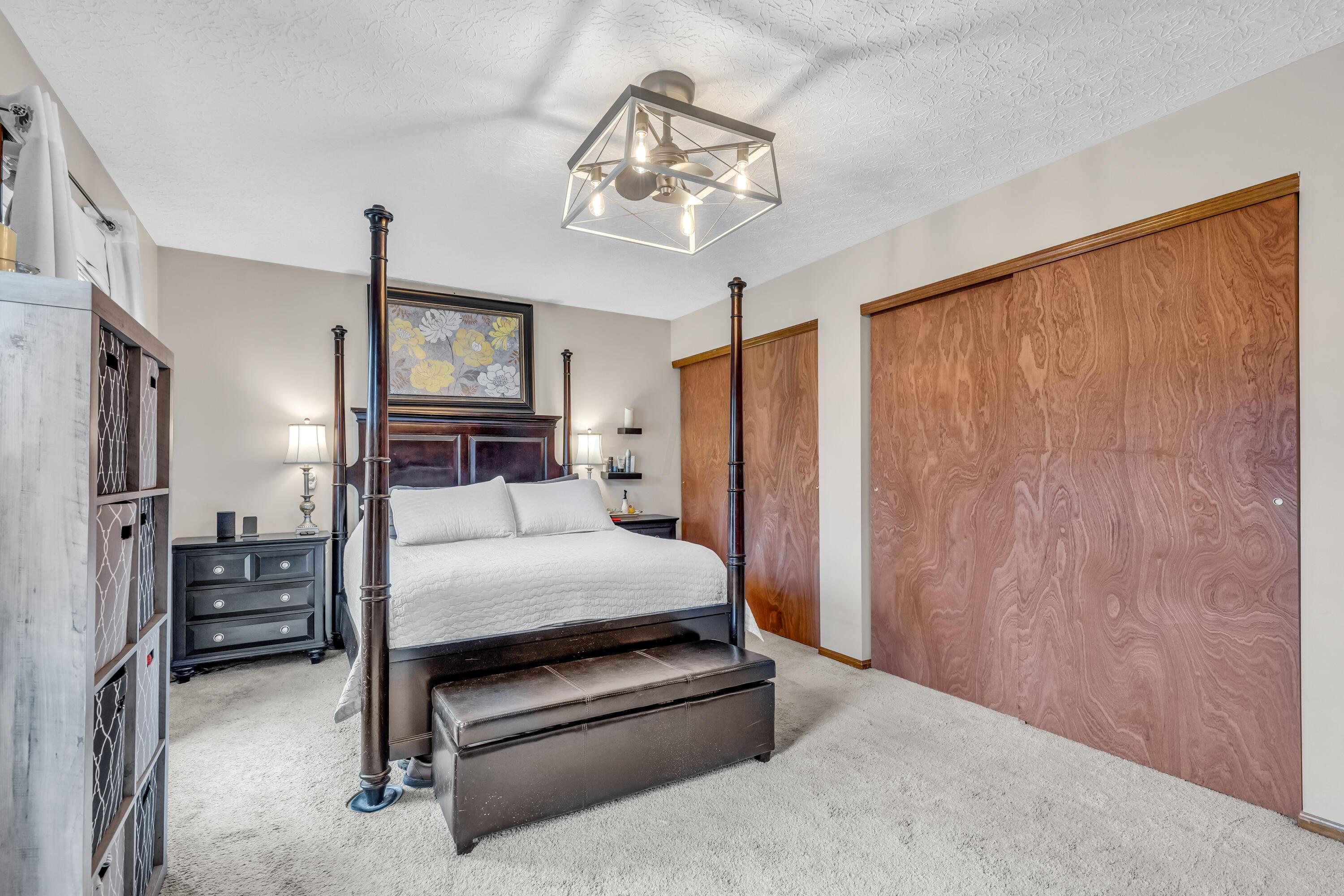 435 Emory Street Gahanna, OH 43230 - Photo 24 of 54 • Light sand carpet
• Tan painted walls
• New lighted ceiling
fan ~ 2023
• His & Her Closets with
double sliding doors
(one with attic access)
• Drapes and shades remain
• Wall shelves are negotiable