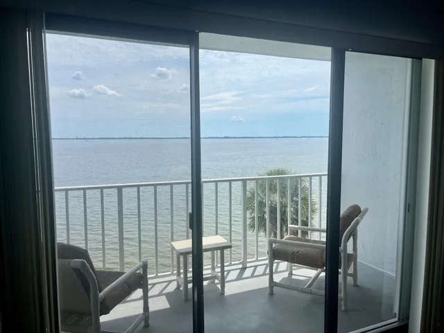 a view of a balcony with chairs