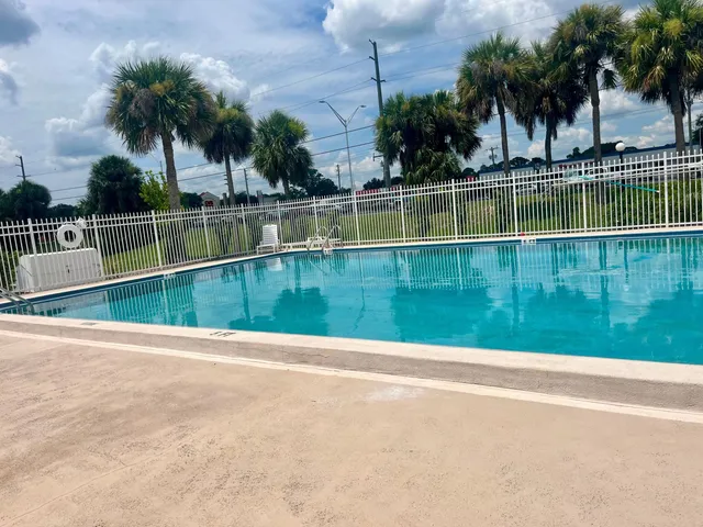 a view of swimming pool with a yard
