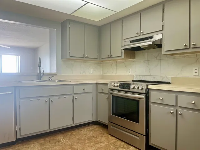 a kitchen with appliances cabinets and a sink