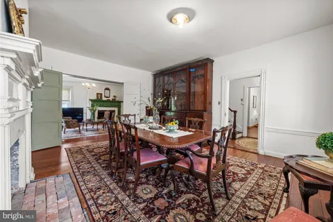 a dining room with furniture and wooden floor