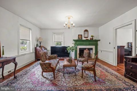 a living room with furniture a fireplace and a window