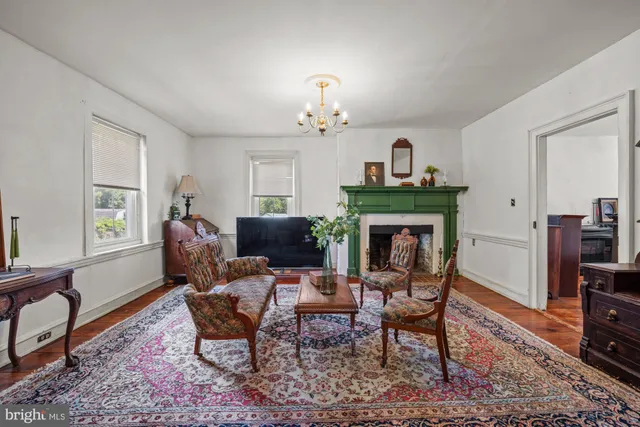 a living room with furniture a fireplace and a window