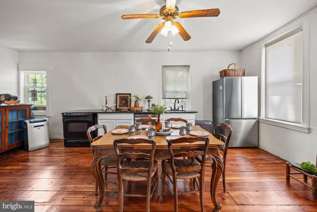 a view of a dining room with furniture and wooden floor
