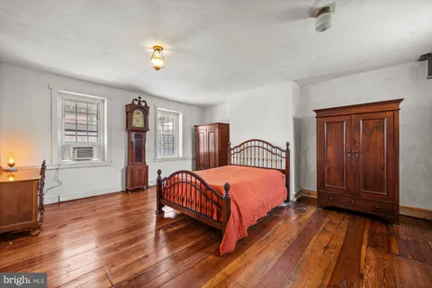 a bedroom with bed and window