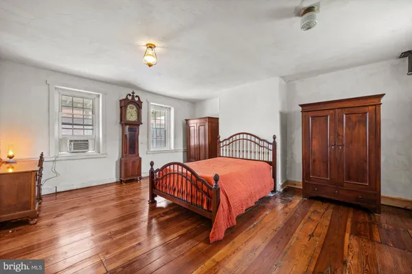 a bedroom with bed and window