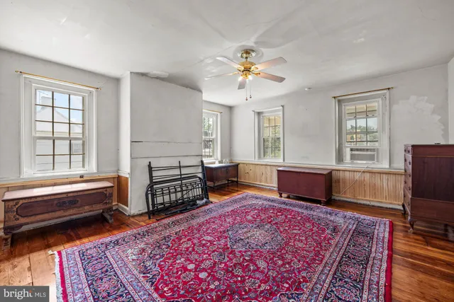 a living room with furniture rug and window