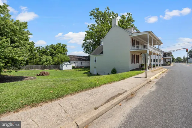 a front view of a house with a garden and yard