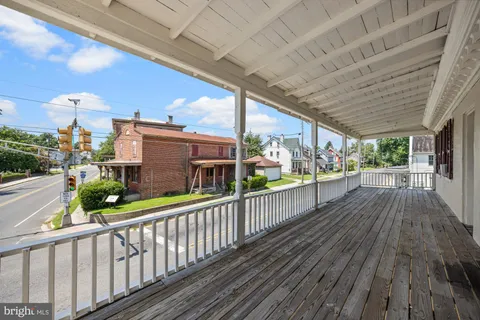 a view of a porch with wooden floor