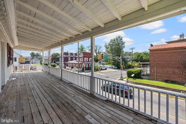a view of a porch with wooden floor