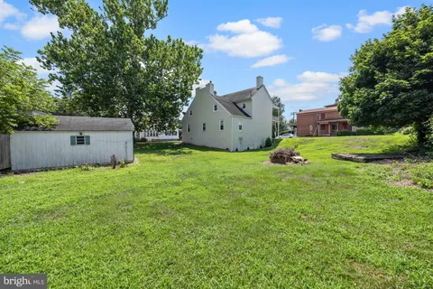 a view of a backyard with large trees