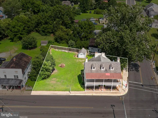 an aerial view of a house with a garden and parking area