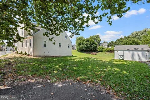 an aerial view of a house with a garden and lake view