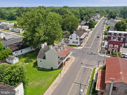 an aerial view of a house with a garden and trees