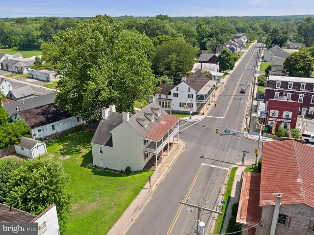 an aerial view of a house with a garden and trees