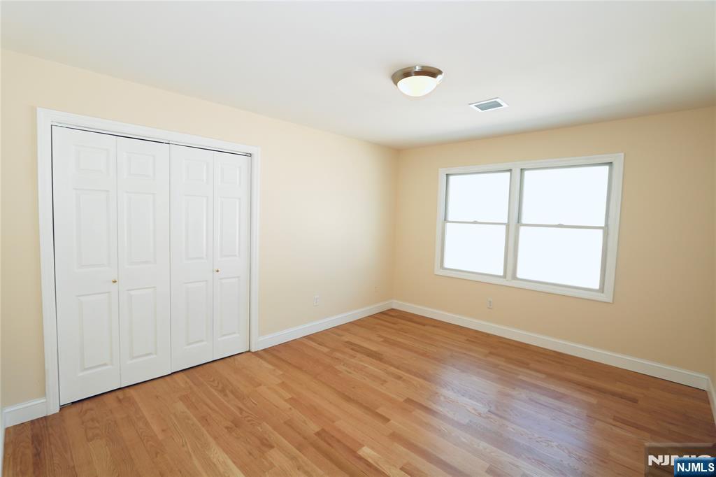 23 Main Avenue Wallington, NJ 07057 - Photo 23 of 29 an empty room with wooden floor and windows