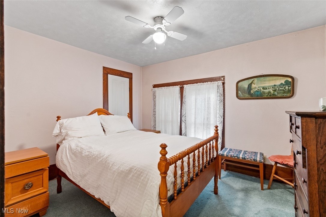 13642 Navarre Road Southwest Beach City, OH 44608 - Photo 21 of 33 Carpeted bedroom with a textured ceiling and ceiling fan