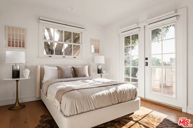 a bedroom with a bed and a large window