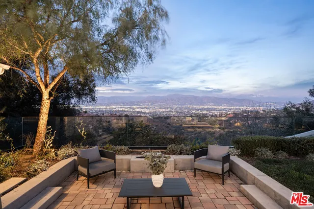 a view of a terrace with couches and a potted plant