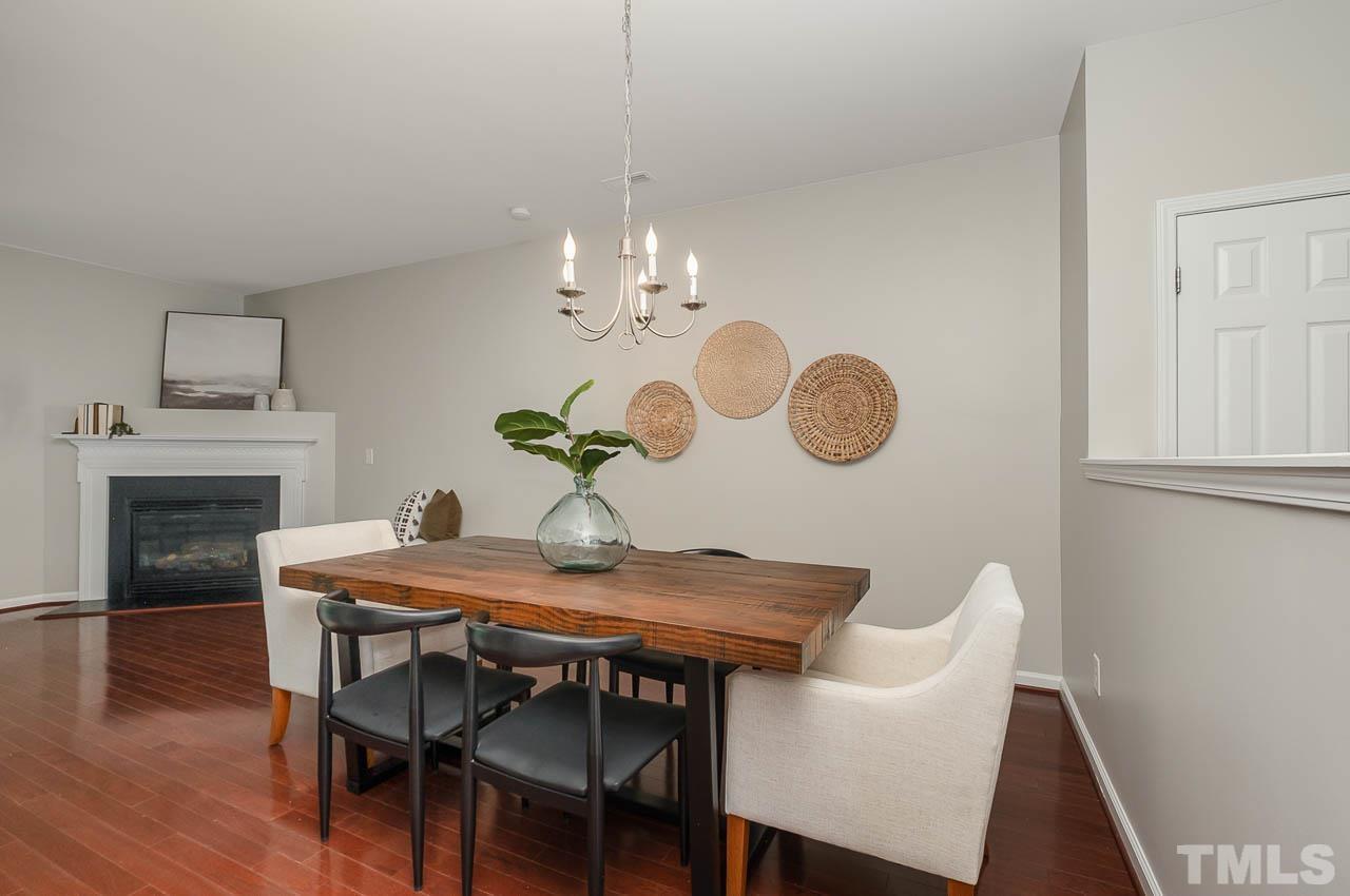 1658 Snow Mass Way Durham, NC 27713 - Photo 11 of 26 a view of a dining room with furniture and wooden floor