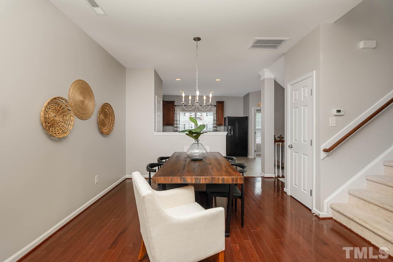1658 Snow Mass Way Durham, NC 27713 - Photo 12 of 26 a living room with furniture and a chandelier