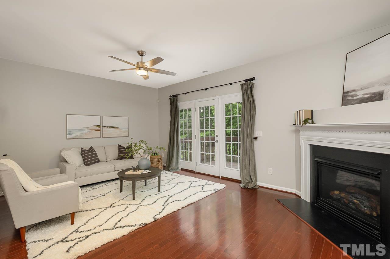 1658 Snow Mass Way Durham, NC 27713 - Photo 13 of 26 a living room with furniture a fireplace and a flat screen tv