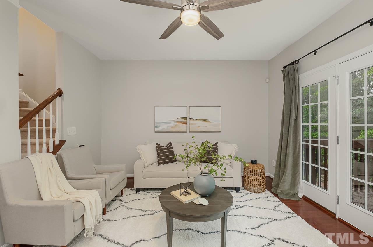 1658 Snow Mass Way Durham, NC 27713 - Photo 14 of 26 a living room with furniture and floor to ceiling windows