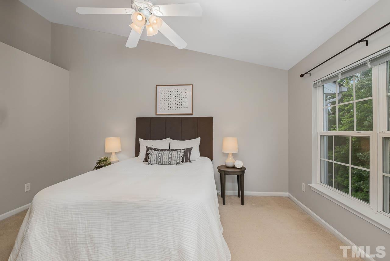 1658 Snow Mass Way Durham, NC 27713 - Photo 18 of 26 a large bed sitting in a bedroom next to a window