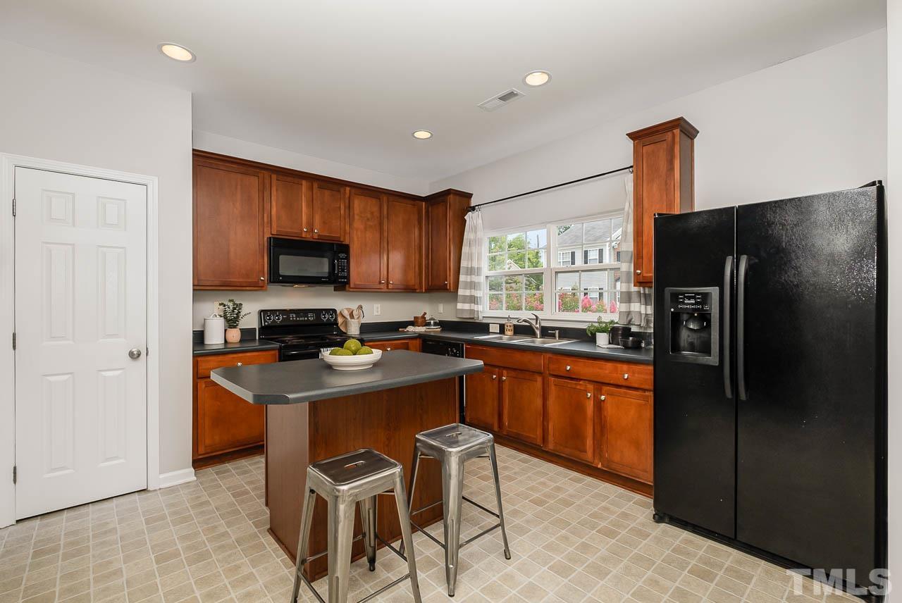 1658 Snow Mass Way Durham, NC 27713 - Photo 7 of 26 a kitchen with stainless steel appliances granite countertop a refrigerator and a stove top oven