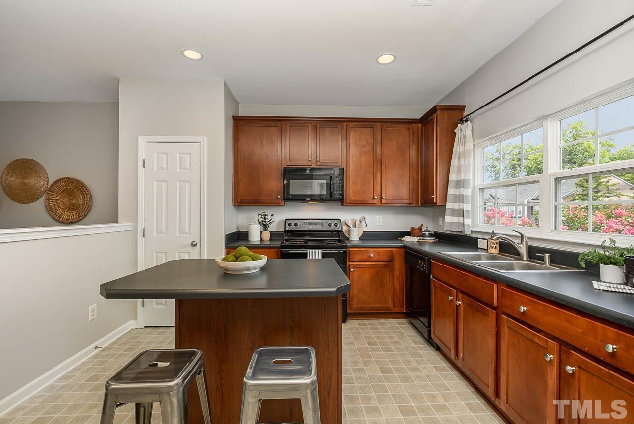 1658 Snow Mass Way Durham, NC 27713 - Photo 9 of 26 a kitchen with stainless steel appliances granite countertop a stove a sink and a microwave