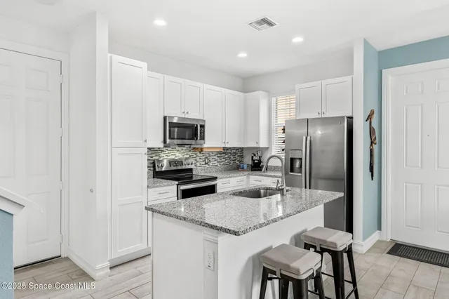 a kitchen with a stove sink and refrigerator
